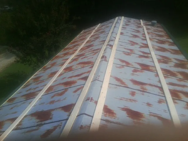 Rusted metal roof panels with new wood purlins before replacement — Storm Damage Roof Repair in Richlandtown by Roofing Brothers