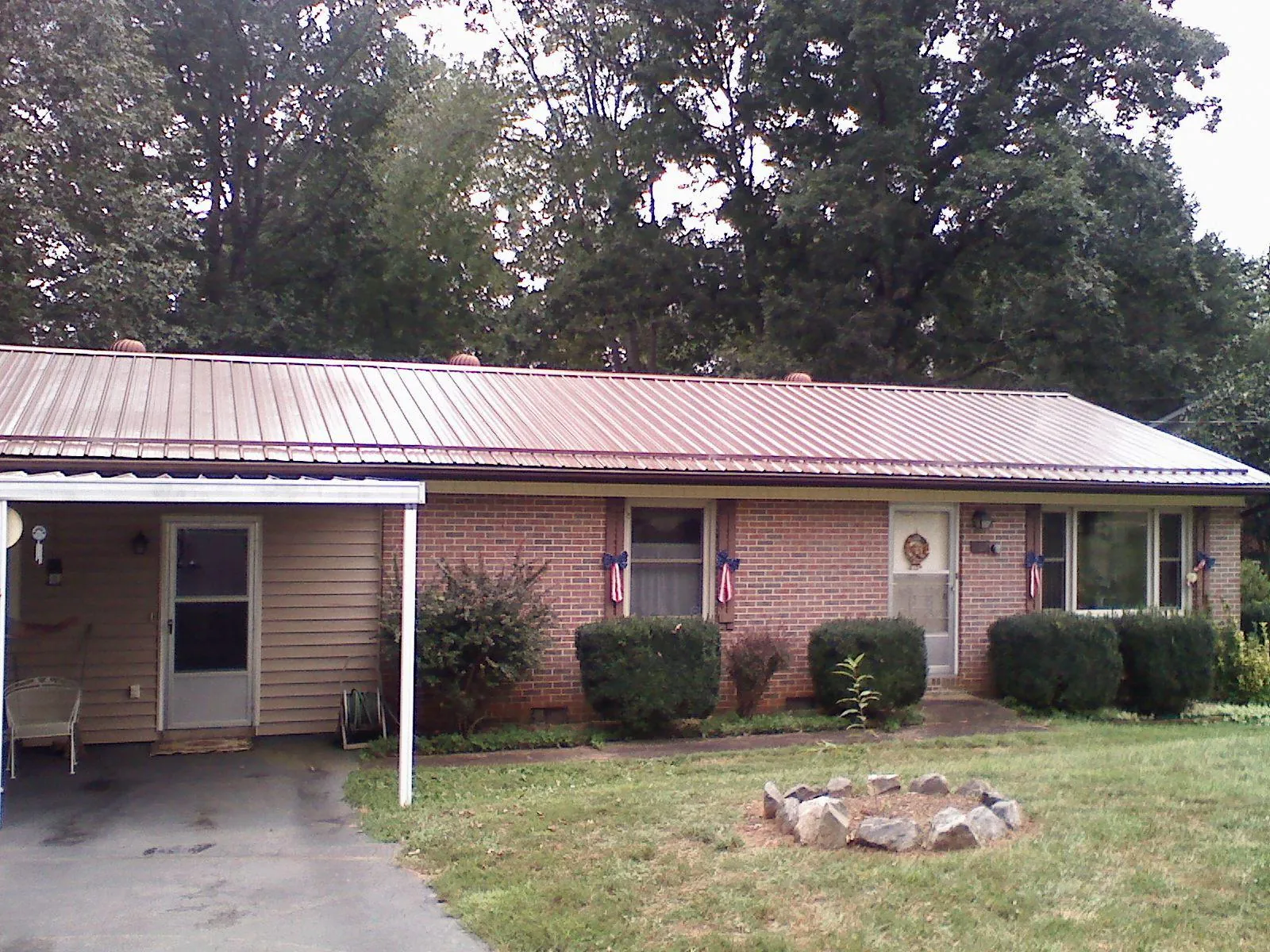 Bronze metal roof and carport on a brick ranch home — Roof Repair work by our crew in Richlandtown
